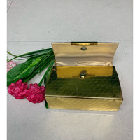 Gold box-shaped sling bag.