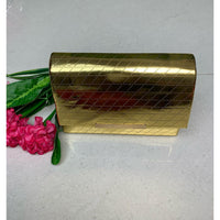 Gold box-shaped sling bag.